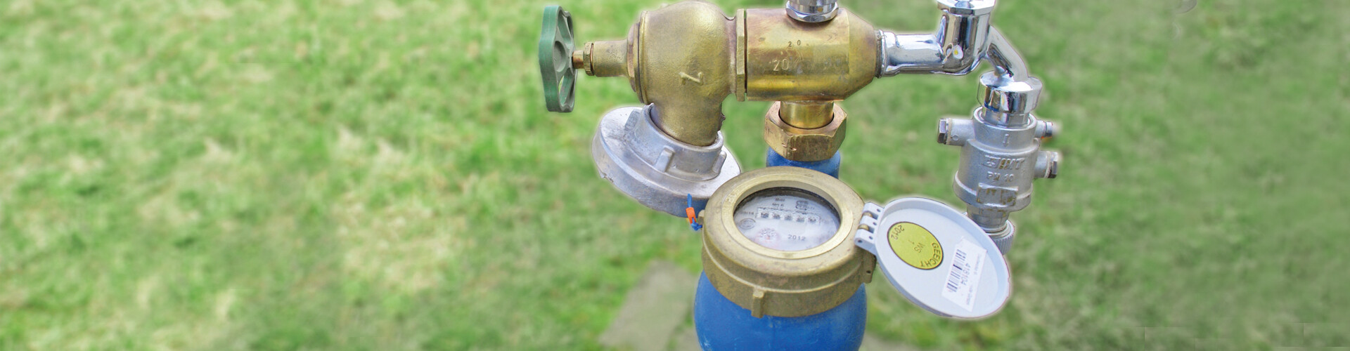 Anschluss für Bauwasser auf grüner Wiese.